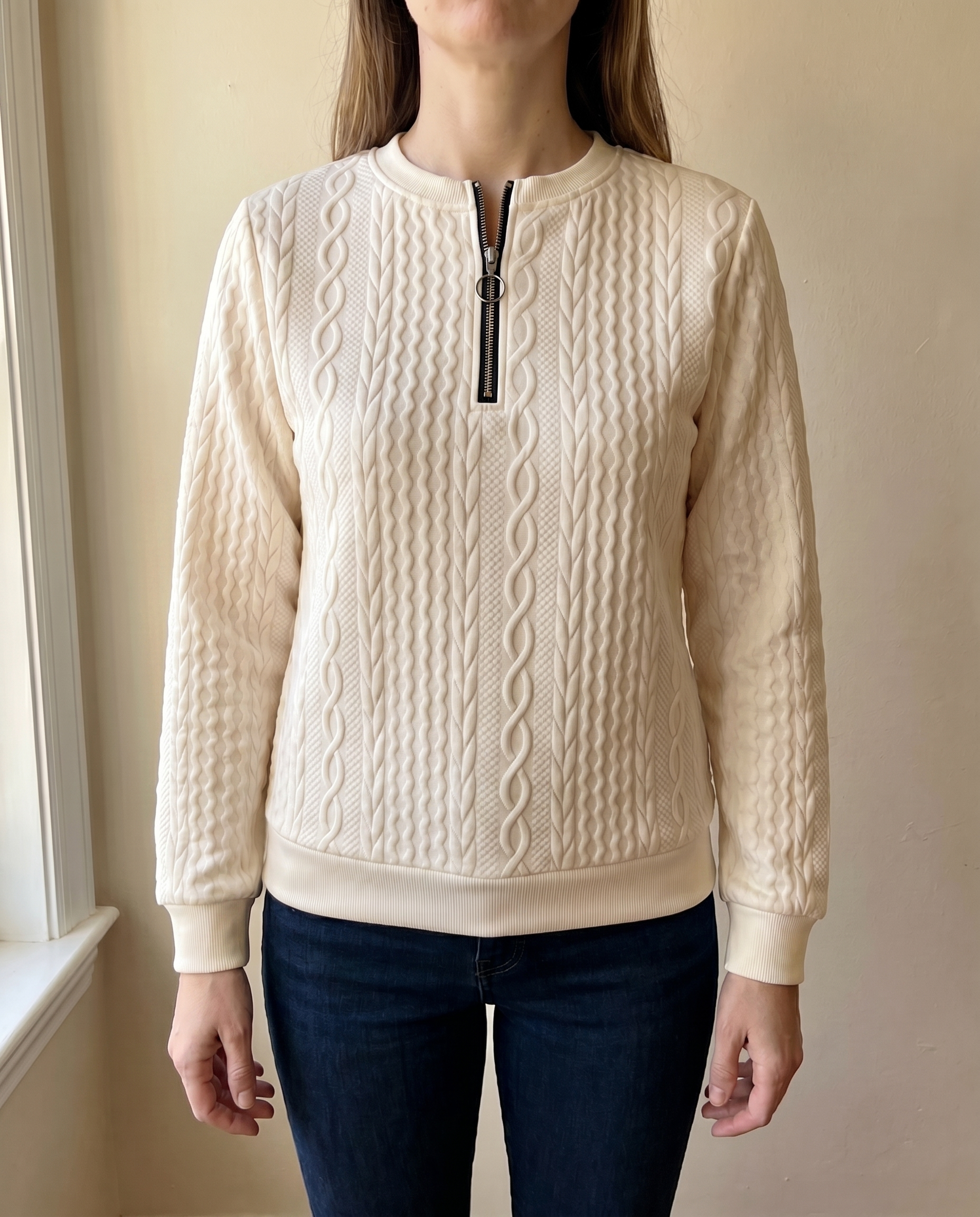 Close-up of the high zip neck on the cream Gastown Textured Zip Sweatshirt